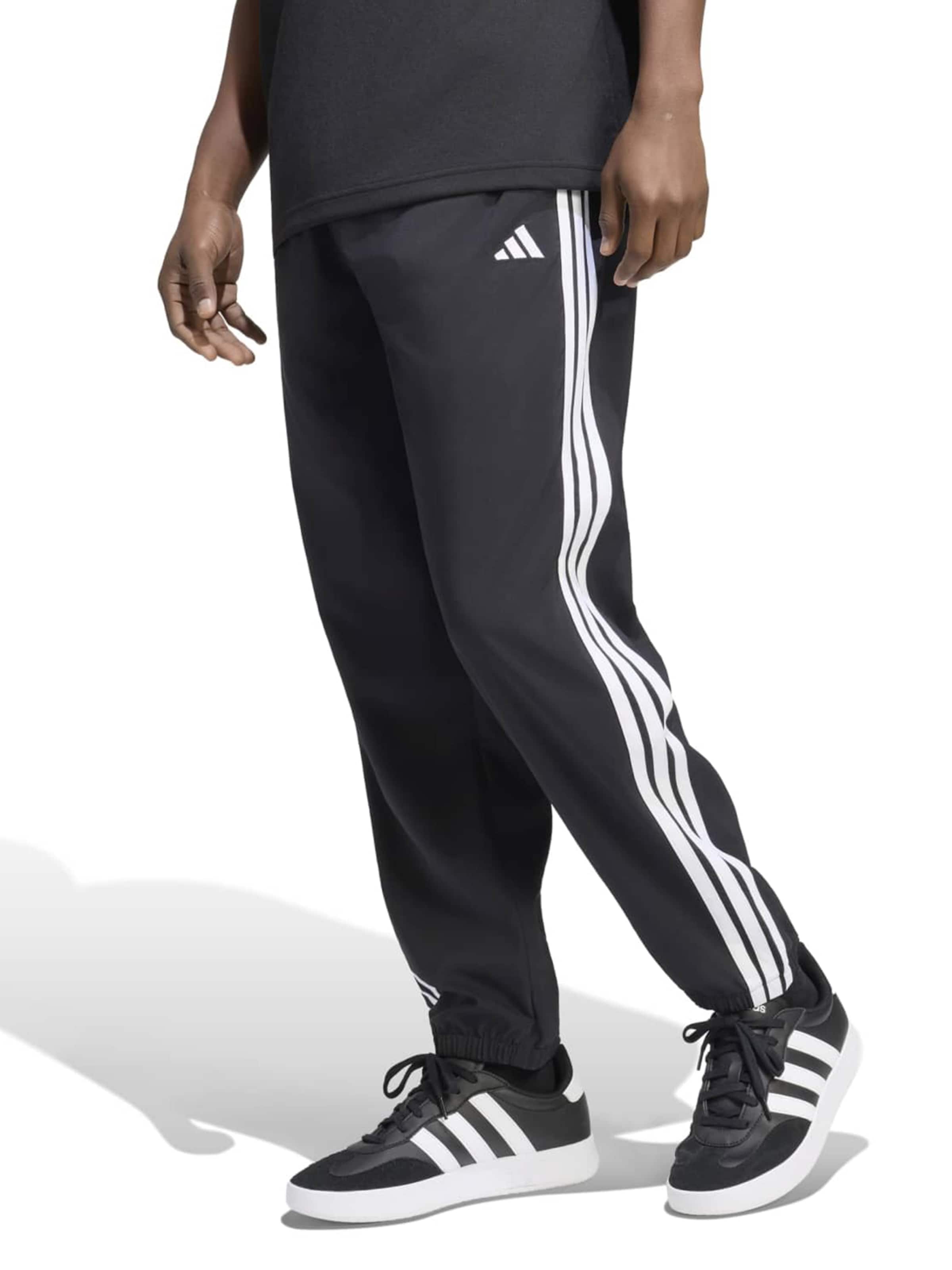 ADIDAS SPORTSWEAR Tapered Workout Pants in Black: front