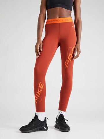 Skinny Pantalon de sport NIKE en orange : devant