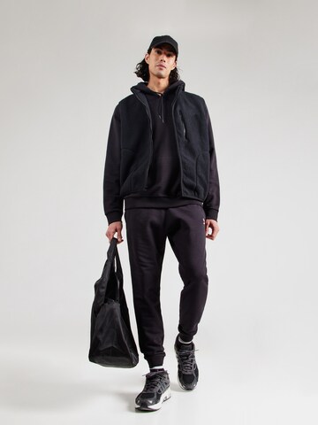 Tapered Pantaloni sportivi di Reebok in nero