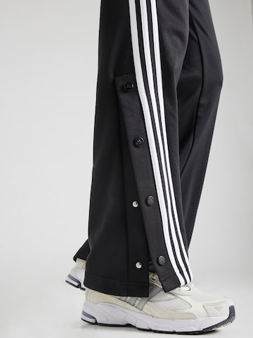 ADIDAS SPORTSWEAR Bootcut Urheiluhousut 'Iconic Warpping 3-Stripes Snap' värissä musta