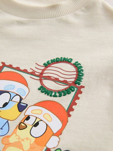 Tricou de la Next pe bej