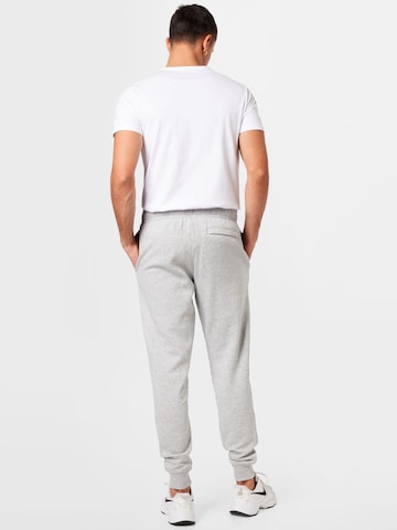 Effilé Pantalon de sport 'Rival' UNDER ARMOUR en gris