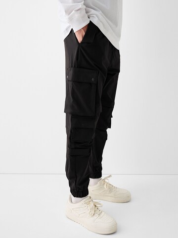 Bershka Tapered Cargo trousers in Black