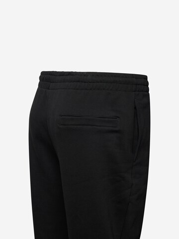 Tapered Pantaloni di Urban Classics in nero