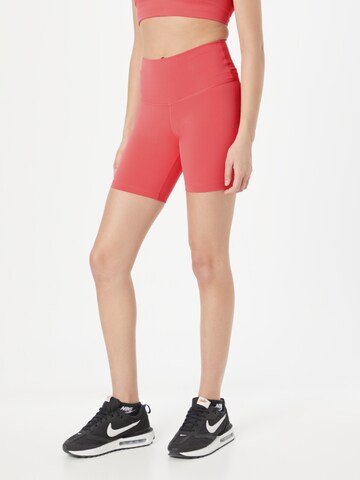 NIKE Skinny Workout Pants in Orange: front