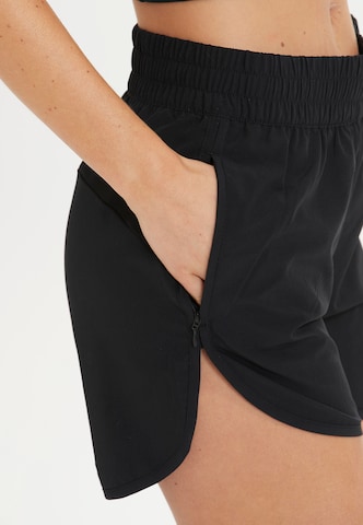 Athlecia Regular Workout Pants 'Creme' in Black