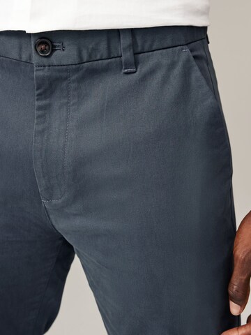 Next Slimfit Chinohousut värissä sininen