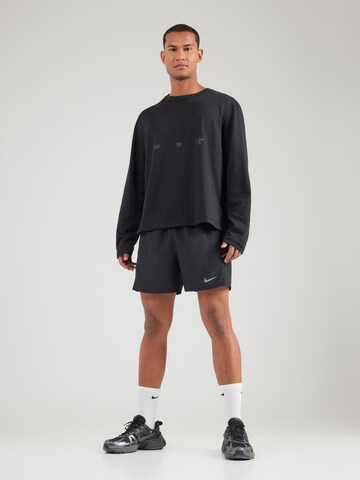 regular Pantaloni sportivi 'MILER' di NIKE in nero