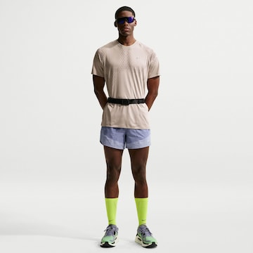 NIKE Regular Workout Pants 'Stride Nvlty' in Purple