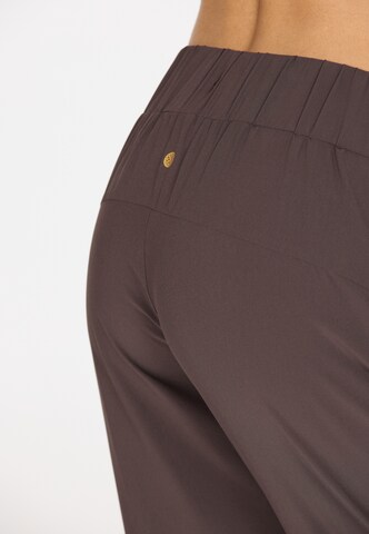Athlecia Tapered Sports trousers 'Austberg' in Brown