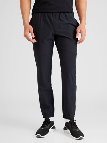 Effilé Pantalon de sport UNDER ARMOUR en noir : devant