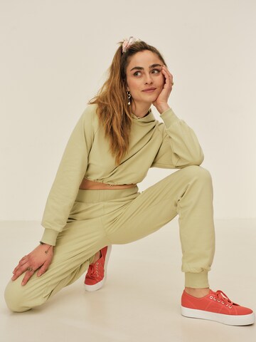 ABOUT YOU x Sofia Tsakiridou Regular Trousers 'Nora' in Green