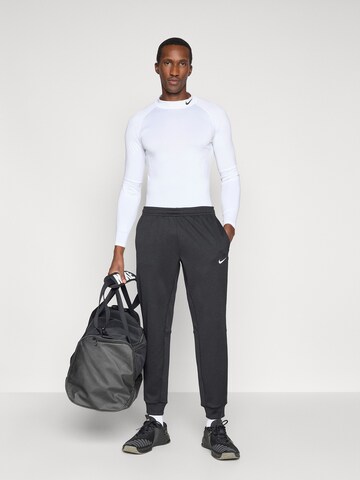 NIKE Tapered Sportnadrágok 'FLEX' - fekete