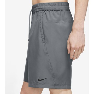 NIKE - Regular Calças de desporto em cinzento