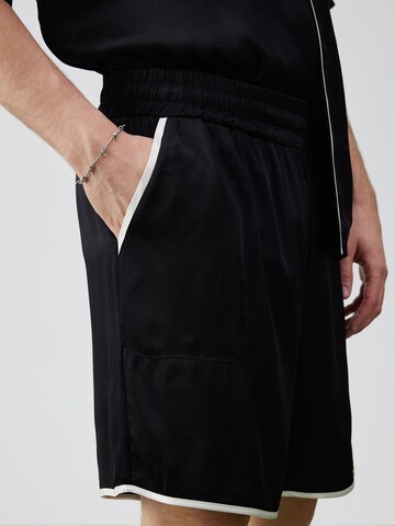 ABOUT YOU x Rewinside Loose fit Pants 'Aras' in Black