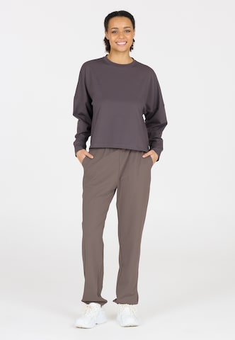 Athlecia Regular Sports trousers in Brown