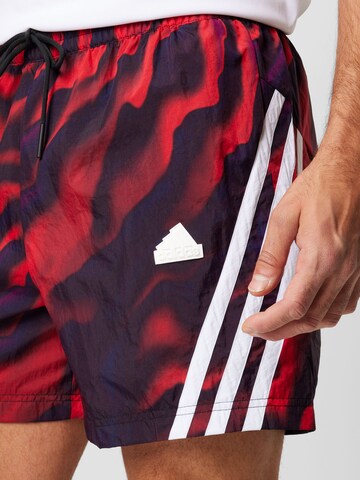 ADIDAS SPORTSWEAR Štandardný strih Športové nohavice 'Future Icons Allover Print' - Červená