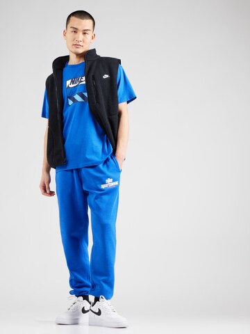 Tapered Pantaloni 'CLUB' di Nike Sportswear in blu