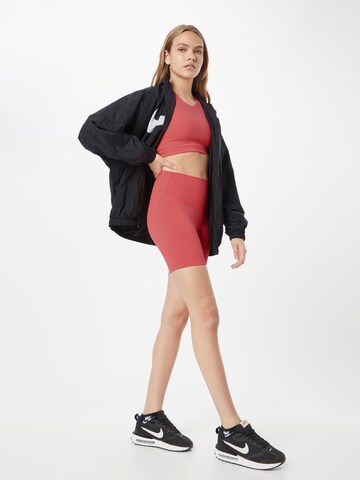 NIKE Skinny Spodnie sportowe w kolorze pomarańczowy