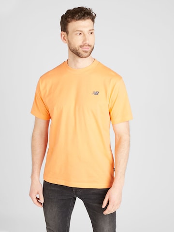 new balance Koszulka w kolorze pomarańczowy: przód