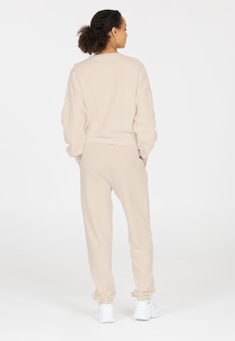 Athlecia Regular Sports trousers in Beige
