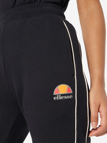 ELLESSE Zwężany krój Spodnie sportowe 'America' w kolorze czarny