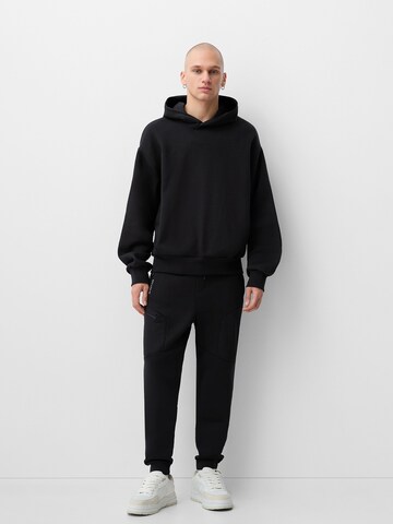 Bershka Tapered Bukser i sort