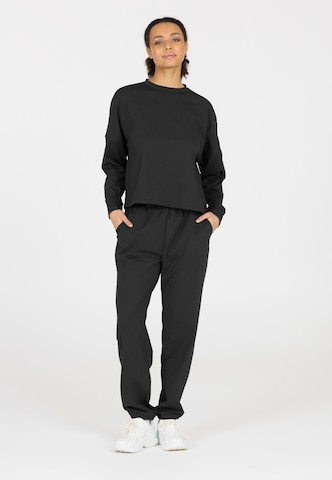 Athlecia Regular Sports trousers in Black: front