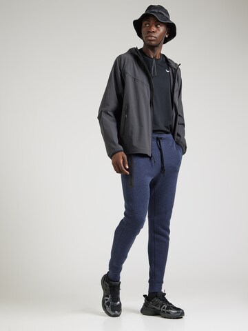 Nike Sportswear Zúžený Kalhoty 'TECH FLEECE' – modrá