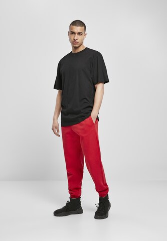 Tapered Pantaloni di Urban Classics in rosso