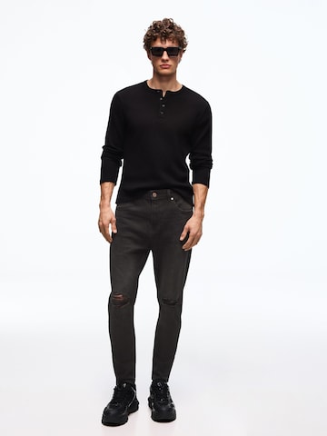 Bershka Tapered Jeans i sort