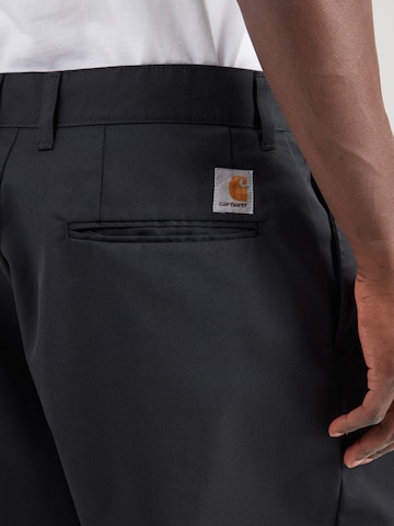 Carhartt WIP Bő szár Élére vasalt nadrágok 'Evan' - fekete