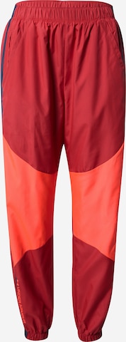 UNDER ARMOUR Tapered Workout Pants in Red: front
