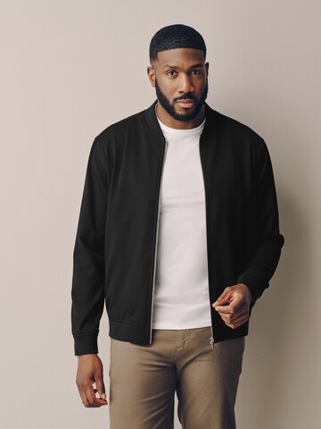 Next - Chaqueta de entretiempo 'Motionflex' en negro: frente