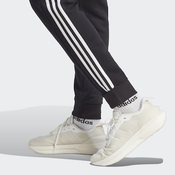 ADIDAS SPORTSWEAR Tapered Παντελόνι φόρμας 'Essentials' σε μαύρο