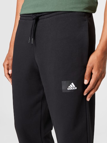 ADIDAS SPORTSWEAR Tapered Workout Pants 'Essentials Feelvivid  Fleece Straight' in Black