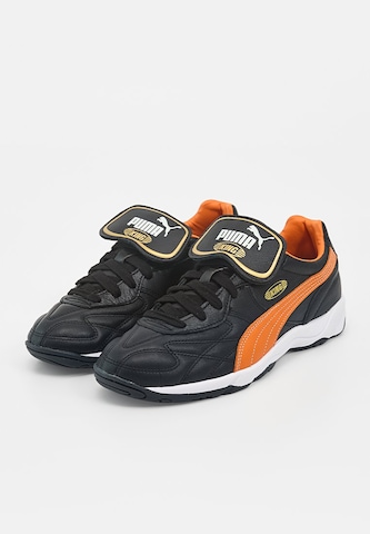 Chaussure de foot 'King' PUMA en noir : devant