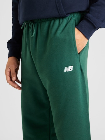 new balance Zwężany krój Spodnie w kolorze zielony