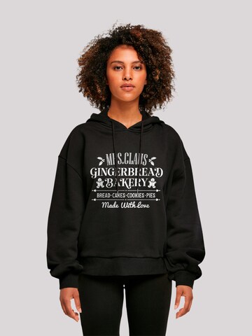 Sweat-shirt 'Santas Gingerbread Bakery Retro Christmas' F4NT4STIC en noir : devant