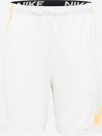 NIKE Sports trousers in White: front