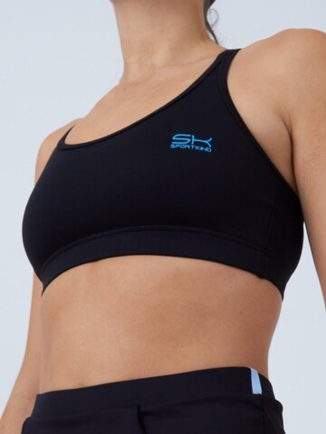 SPORTKIND Medium Support Sport-BH 'Crossed Straps'‌‌‌ in Schwarz