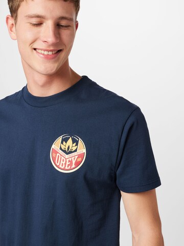 Obey T-Shirt  'CATCH A FIRE' in Blau