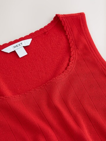 Haut Next en rouge