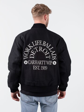 Carhartt WIP Übergangsjacke 'Work Varsity' in Schwarz