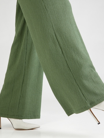 ABOUT YOU Loose fit Trousers 'Emina' in Green