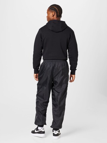 Tapered Pantaloni de la Nike Sportswear pe negru