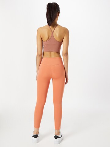 NIKE Skinny Sportbroek in Oranje