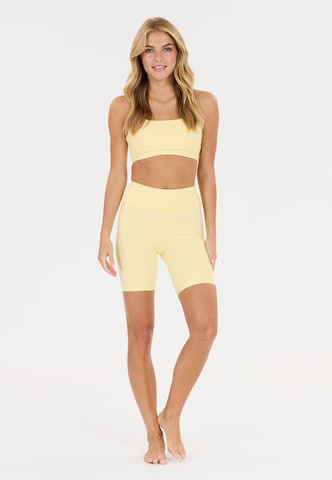 Athlecia Slim fit Sports trousers 'Blossom' in Yellow