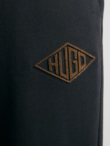 Tapered Pantaloni 'Dacusi' di HUGO in nero