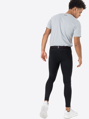 UNDER ARMOUR Skinny Urheiluhousut 'Rush' värissä musta